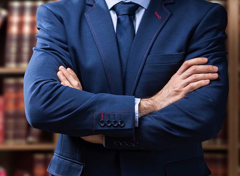 Young OVI Lawyer standing folding hands
